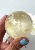 Load and play video in Gallery viewer, Small Honey Calcite Sphere| Optical Honey Calcite | Reiki | Home Decor | Gifts
